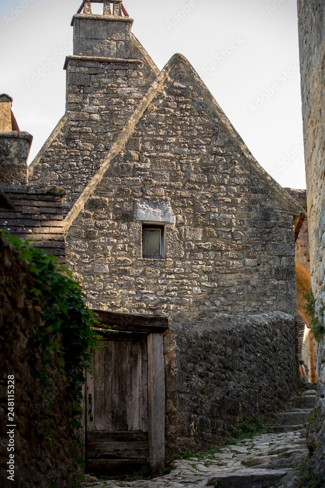 Typical French townscape with ancient housest and cobblestone street in the traditional town Beynac-et-Cazenac, France Typical French townscape with ancient housest and cobblestone street in the traditional town Beynac-et-Cazenac, France