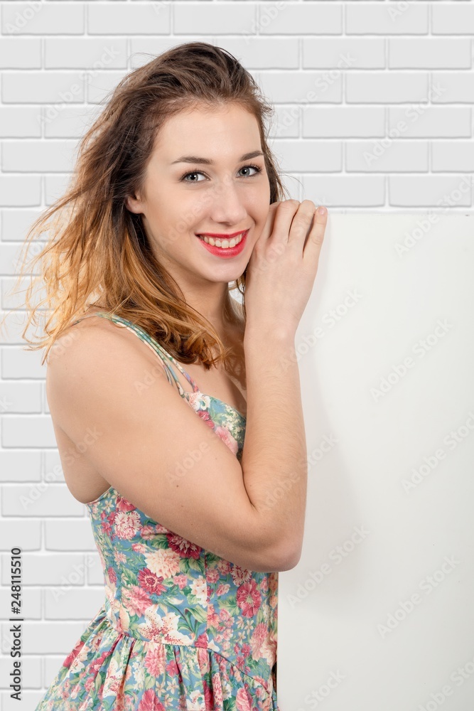 smiling young woman showing empty blank signboard with copyspace smiling young woman showing empty blank signboard with copyspace