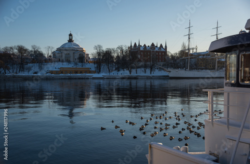 A cold winter morning in Stockholm with snow and ice on islands and boats photo