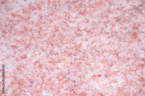 Texture sea pink salt. Useful spa treatments. Pink salt granules.