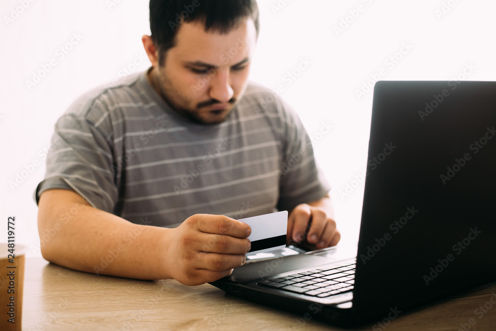 Cropped picture of man with credit card white pattern and phone Cropped picture of man with credit card white pattern and phone