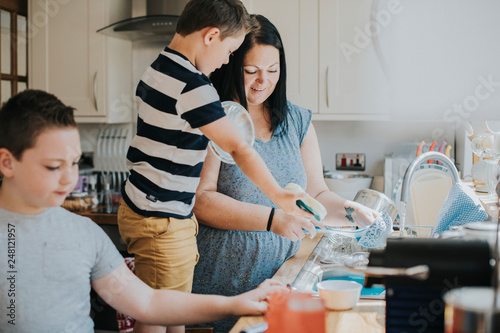 Family cleaning in the kitchen photo