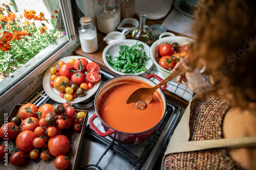 Obraz na plátně Homemade tomato soup cooking in the kitchen