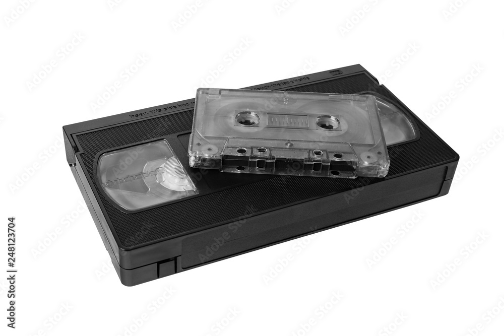 audio tape cassette and VHS video tape cassette on white background