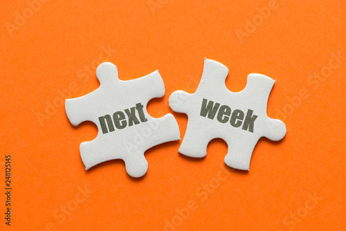 The word Next week on two matching puzzle on orange background