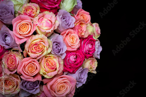 Beautiful bouquet of roses in a gift box. Bouquet of pink roses. Pink roses close-up. on black background  with space for text.