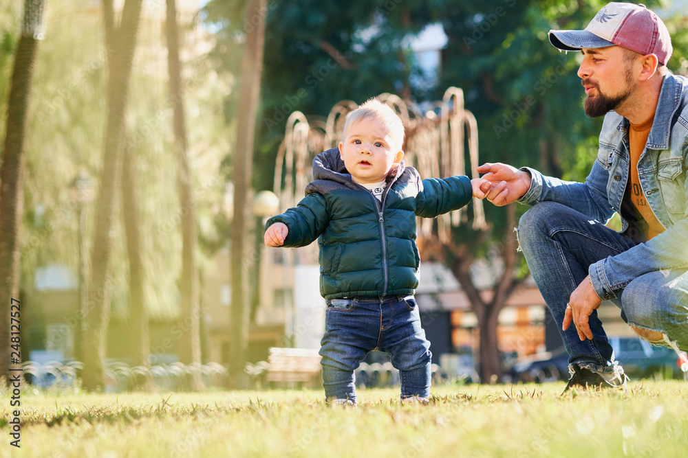 Happy young father walking with his little son Happy young father walking with his little son