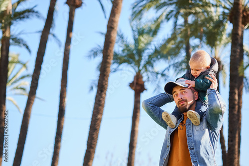 Happy man holding his son on neck