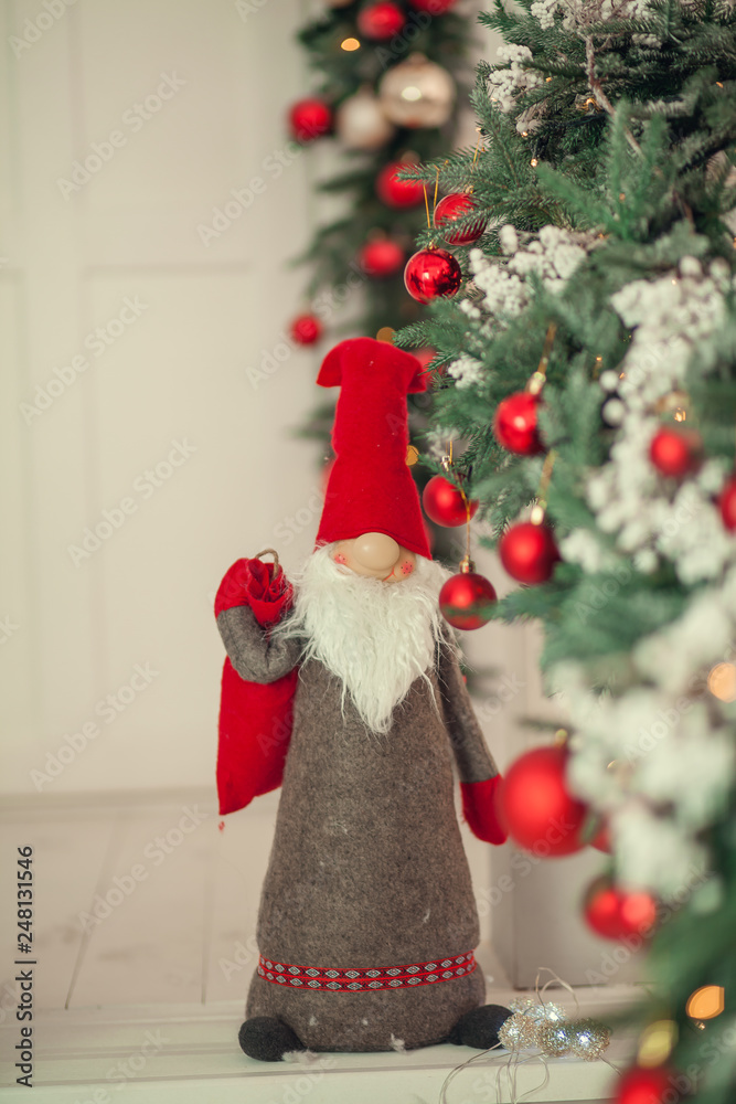 Fototapeta premium Christmas background with xmas tree, on a wooden white background. Merry christmas card. Winter holiday theme. Happy New Year. Space for text.