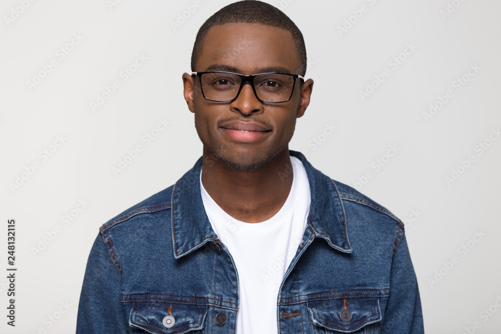 Confident young african man looking at camera isolated on background Confident young african man looking at camera isolated on background