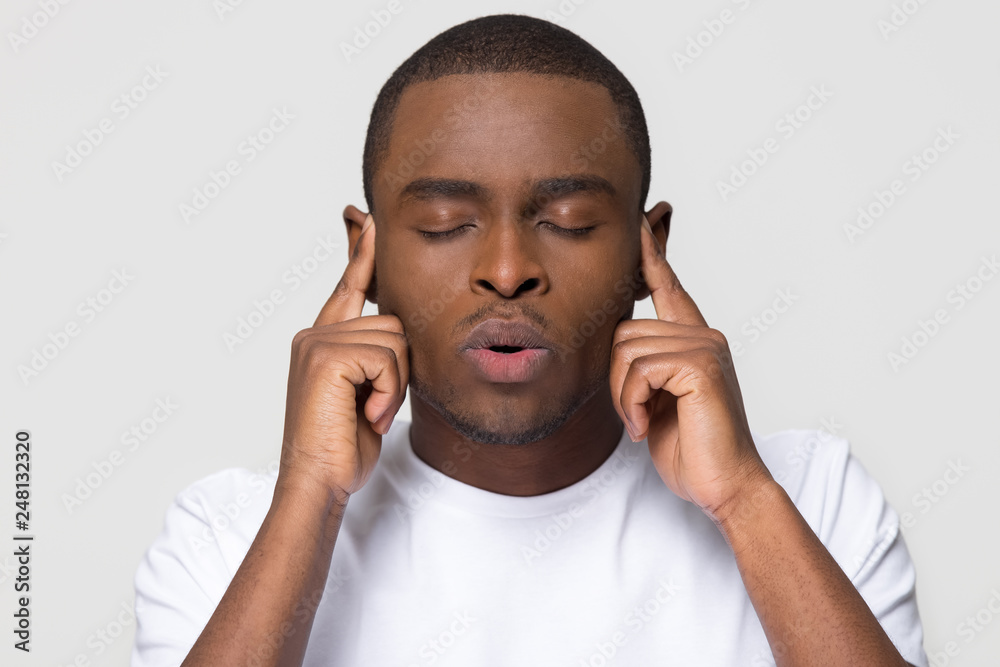 Stressed nervous african american man breathing out for stress relief Stressed nervous african american man breathing out for stress relief