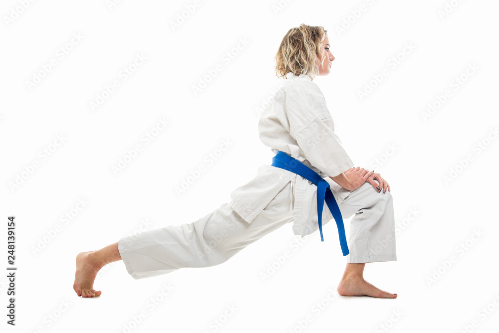 Full body of woman wearing martial arts outfit stretching Full body of woman wearing martial arts outfit stretching
