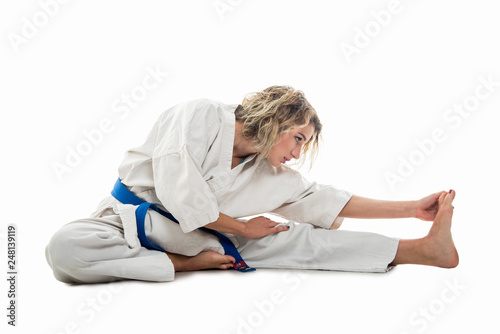 Full body of woman wearing martial arts outfit stretching