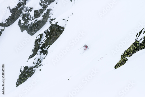 Man skiing in fresh powder in the mountain