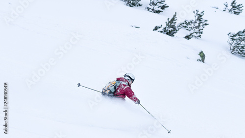 Man skiing in fresh powder in the mountain