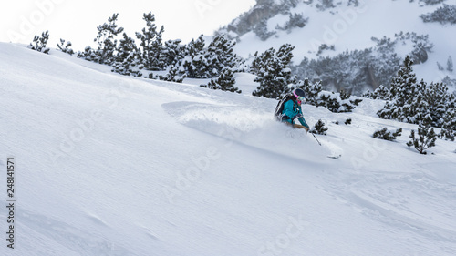 Young woman skiing fresh snow in the mountain