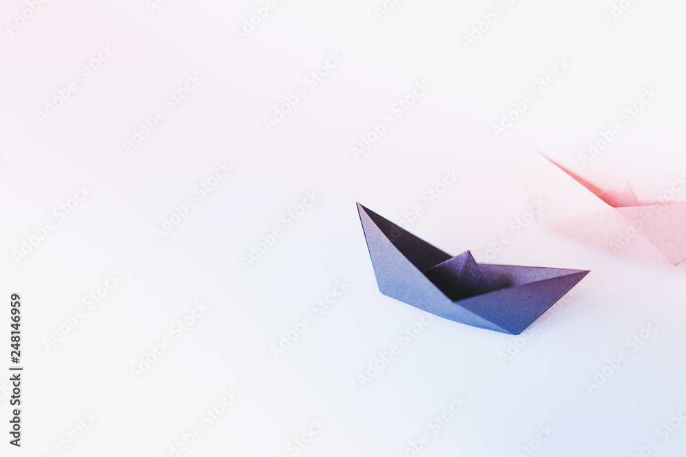 Naklejka premium two paper boat on clean background with copy space, learning and education concept