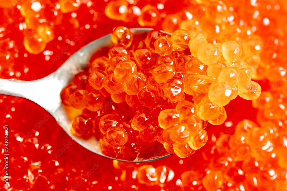 Red caviar on the spoon as a background Red caviar on the spoon as a background
