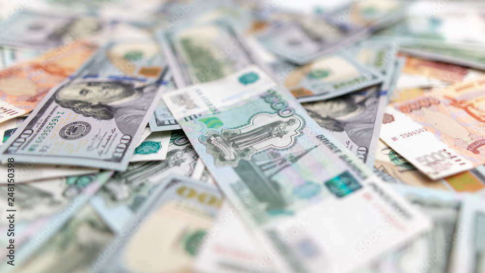 Dollars and Russian rubles on the table as background Dollars and Russian rubles on the table as background