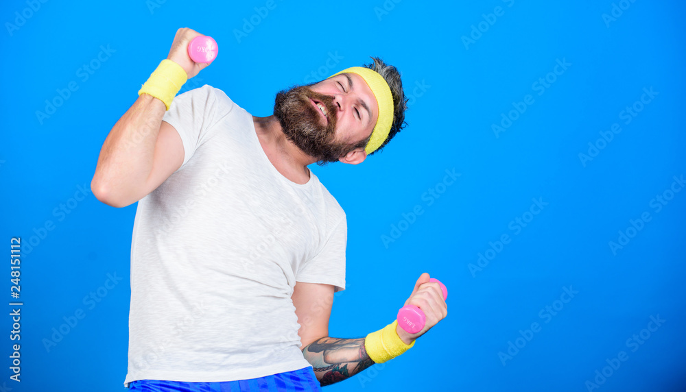 Athlete training with tiny dumbbell. Motivated athlete guy. Sportsman training with dumbbells blue background. Improve your muscles. Use weights or dumbbells. Man bearded athlete exercising dumbbell Athlete training with tiny dumbbell. Motivated athlete guy. Sportsman training with dumbbells blue background. Improve your muscles. Use weights or dumbbells. Man bearded athlete exercising dumbbell