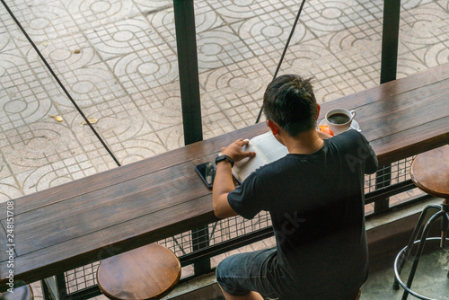 Young man reading books in the coffee shop