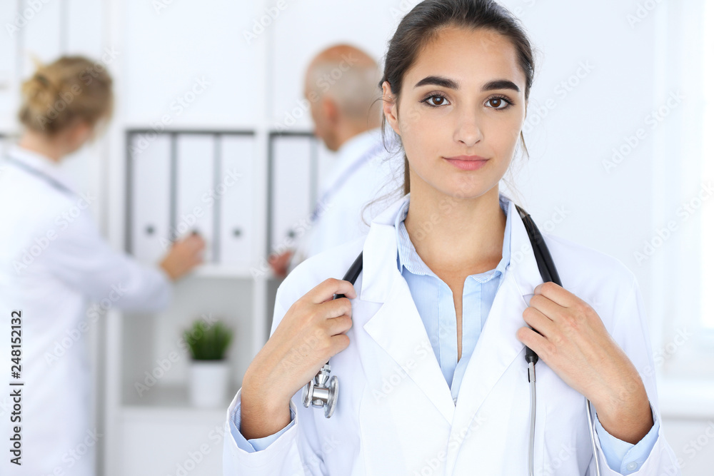 Portrait of young doctor woman in hospital. Hispanic or latin american staff in medicine Portrait of young doctor woman in hospital. Hispanic or latin american staff in medicine