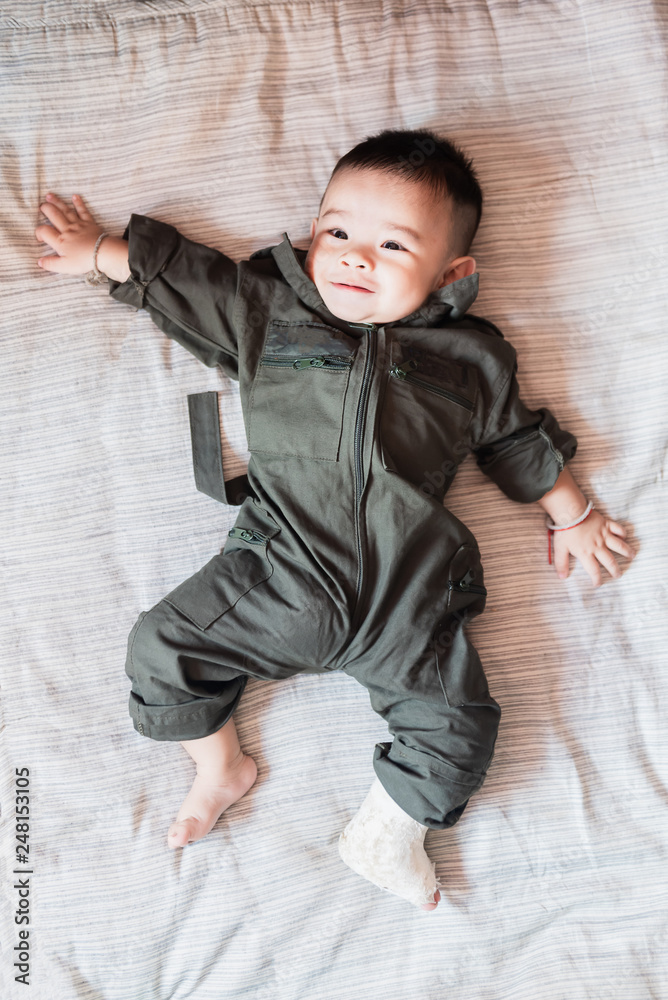 Left leg of Asian Baby litlle child in splint, lay down on bed. Left leg of Asian Baby litlle child in splint, lay down on bed.