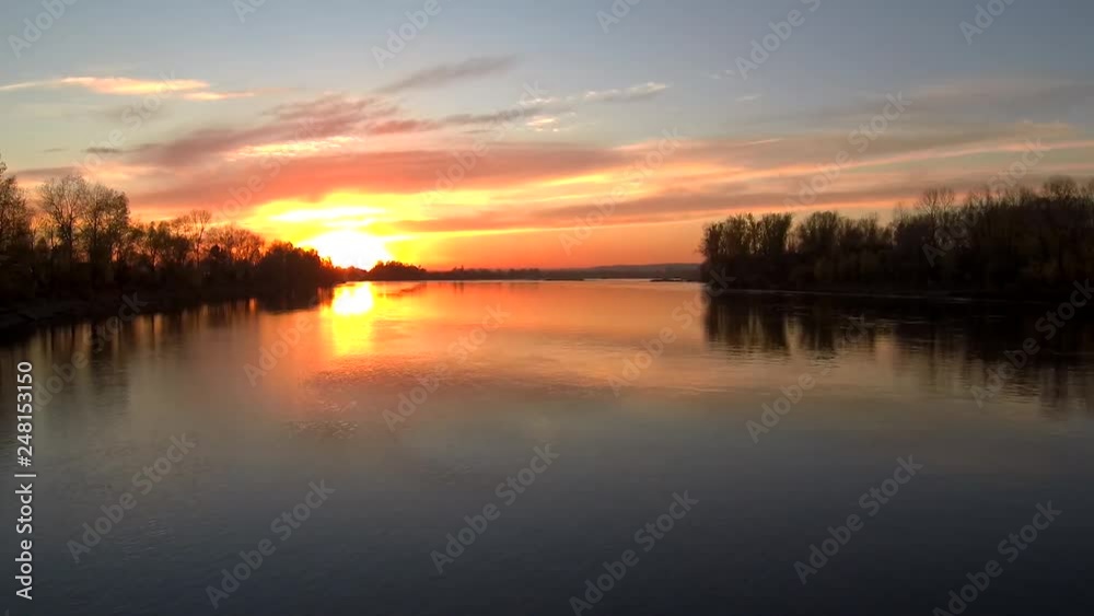 Water surface.Sunset over the river.The reflection in the water.Evening summer landscape.Video from the drone.Flying over the surface of the river.Sunset and cloud mirroring Water surface.Sunset over the river.The reflection in the water.Evening summer landscape.Video from the drone.Flying over the surface of the river.Sunset and cloud mirroring