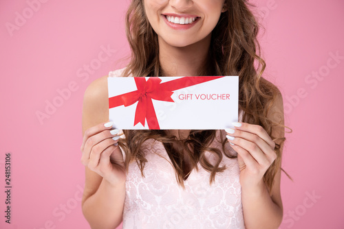 Canvas Print Close up of beautiful woman giving a gift voucher