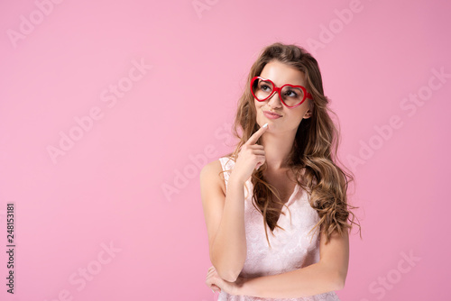 Woman with hand on chin looking at copy space