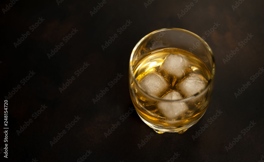 Whiskey with ice on concrete
