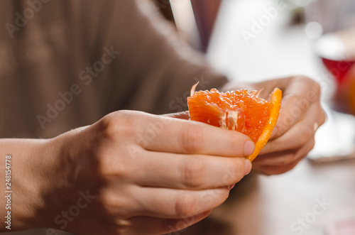Slice of juicy orange in the hand