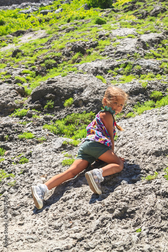 little girl climbing on a mountainside