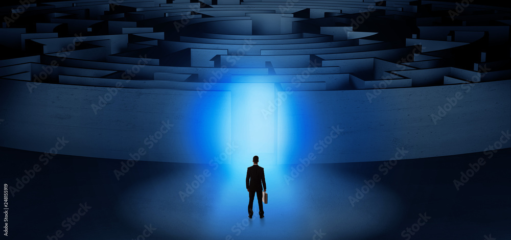Businessman getting ready to enter a concentric labyrinth with lighted entrance concept
