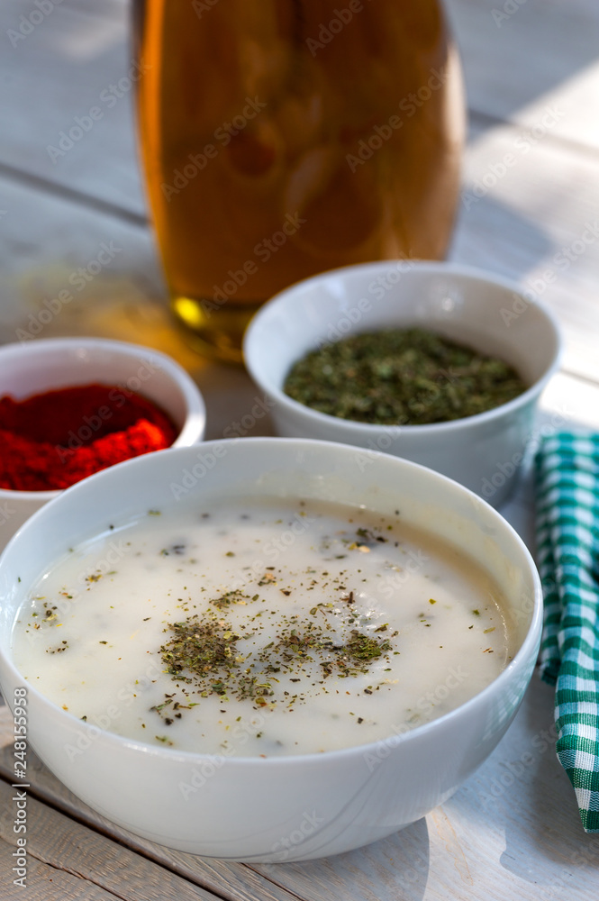 Traditional yayla soup (yoghurt soup) on wooden background Traditional yayla soup (yoghurt soup) on wooden background