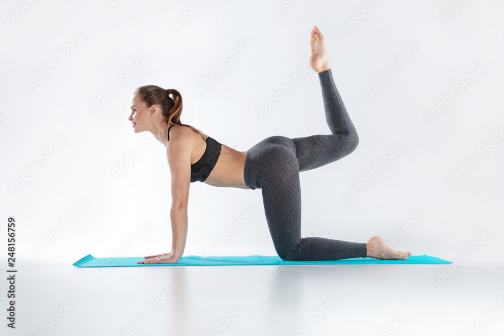 Fototapeta premium Beautiful woman doing sport exercises on mat