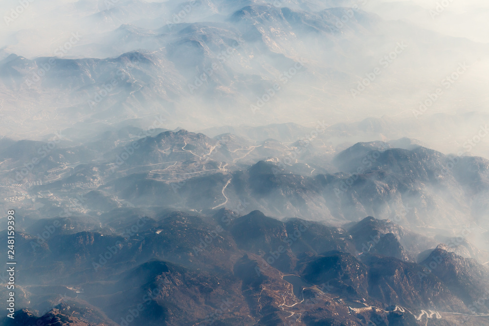 Aerial landscape mountain lost in thick fog in China, bird eye view landscape look like a painting style of chinese