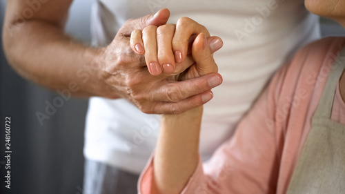 Fototapeta Naklejka Na Ścianę i Meble -  Old husband holding wife hand, spouse care and support, love connection, couple
