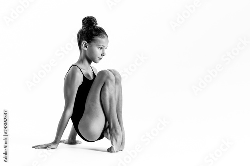 Young gymnast girl stretching and training