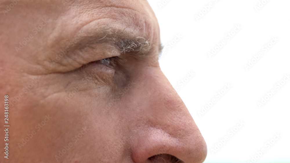 Offended retired man looking into distance, feeling loneliness and despair