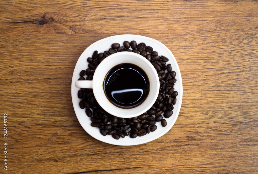 Coffee cup and coffee beans on table Coffee cup and coffee beans on table