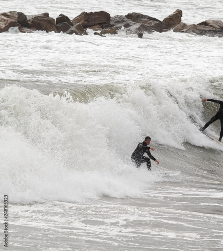 a surfer surf a wave in italy