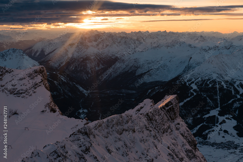 Panoramic view of beautiful snowy Zugspitze mountains on pink sunset. Bavarian Alps, Germany