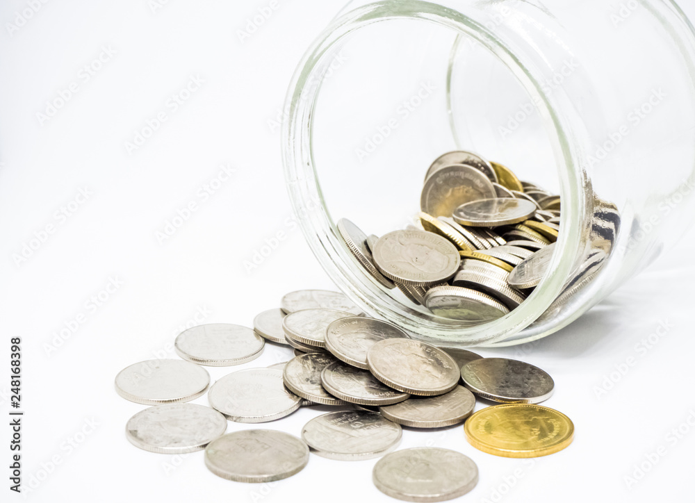 Coins in glass jar isolated on white background. Saving money concept. Coins in glass jar isolated on white background. Saving money concept.
