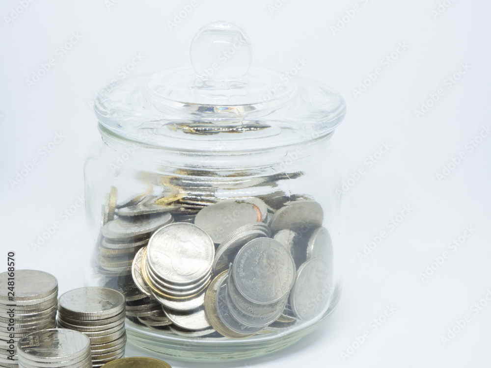 Coins in glass jar isolated on white background. Saving money concept. Coins in glass jar isolated on white background. Saving money concept.