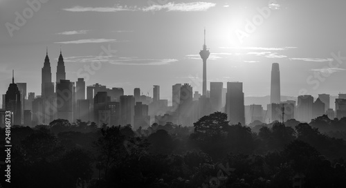 Photography Cityscape of Kuala Lumpur, Malaysia surrounded by trees during sunrise