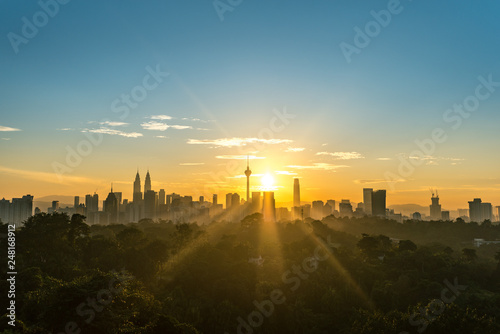 Photography Cityscape of Kuala Lumpur, Malaysia surrounded by trees during sunrise