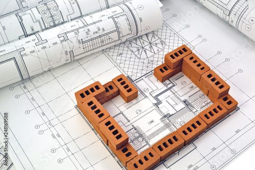 Photos of project drawings and brown bricks 