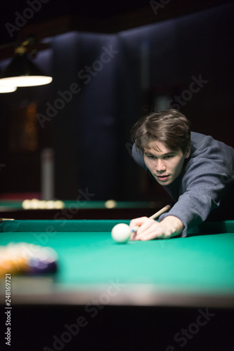 Canvas Print Entertainment concept. A young man playing billiard