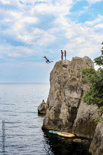 Man jumping off a cliff.